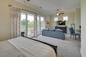 a bedroom with a bed and a living room with a couch at Breezy Myrtle Beach Getaway, 1 Block to Beach! in Myrtle Beach