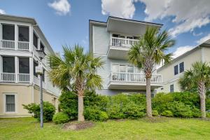 a building with palm trees in front of it at Breezy Myrtle Beach Getaway, 1 Block to Beach! in Myrtle Beach
