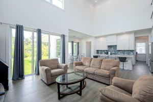 a living room with a couch and chairs and a table at Ocean Estate in Fort Pierce