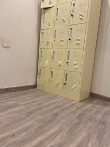 a bunch of lockers in a room with wood floors at Hakimdom Hostel in Riyadh