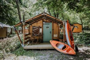 a small shack with a kayak next to it at Sioglamping in Siocamping in Siófok