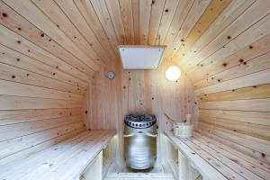 een houten sauna met een kachel in het midden bij S-villa Karuizawa - the forest - in Kita-karuizawa