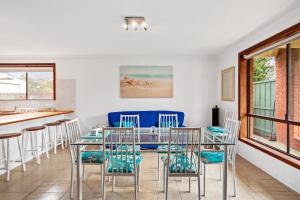 een eetkamer met een glazen tafel en stoelen bij 27 Seashell Avenue Cape Woolamai VIC 3925 in Cape Woolamai