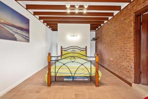 a bed in a room with a brick wall at 27 Seashell Avenue Cape Woolamai VIC 3925 in Cape Woolamai