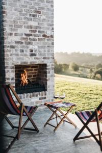 two chairs sitting in front of a brick fireplace at The Brooklet in Brooklet