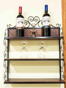 three bottles of wine on a shelf at Pousada & Glamping Terra de Aquários in Aiuruoca