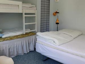 two beds in a room with two bunk beds at 7 person holiday home in TRÄLÖVSLÄGE-By Traum in TrÃ¤slÃ¶vslÃ¤ge