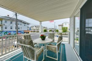 a patio with a table and chairs on a balcony at Condo with Deck Walk to Beach and Convention Center! in Wildwood