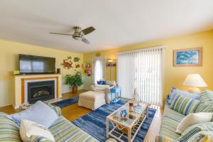 a living room with a couch and a fireplace at Condo with Deck Walk to Beach and Convention Center! in Wildwood