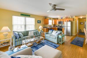a living room with two couches and a kitchen at Condo with Deck Walk to Beach and Convention Center! in Wildwood