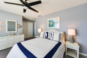 a bedroom with a bed and a ceiling fan at Condo with Deck Walk to Beach and Convention Center! in Wildwood