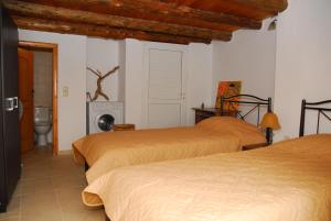 a bedroom with two beds and a toilet in it at Spitaki in Plakias