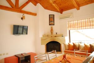 a living room with a couch and a fireplace at Spitaki in Plakias