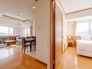 a bedroom with a bed and a dining room at Mountainside Palace in Niseko