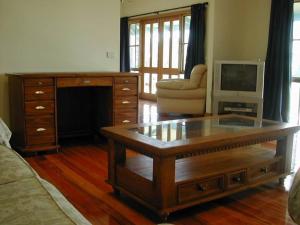 a living room with a coffee table and a tv at Heritage Haven on Phillip Island in Cowes
