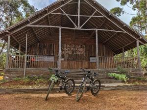 two bikes parked in front of a wooden building at TSIAZOMPANIRY ISLAND LODGE 
