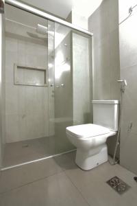 a bathroom with a toilet and a glass shower at Apartamento 910 in Goiânia