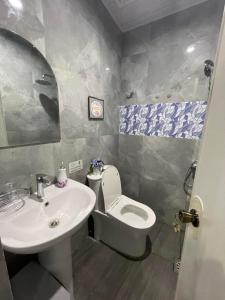 a bathroom with a sink and a toilet at Quirino Hub (402-c) in Davao City