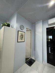 a room with a clock on a white wall at Quirino Hub (402-c) in Davao City +5 photos