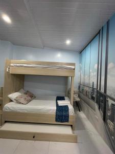 a bedroom with bunk beds with a view of the city at Quirino Hub (402-c) in Davao City