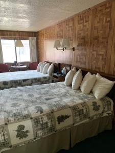 A bed or beds in a room at Ponderosa Lodge