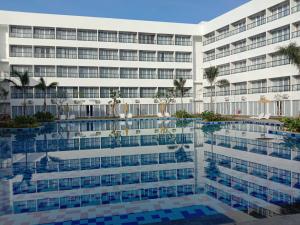 an exterior view of a hotel with a pool at Raja Hotel Kuta Mandalika Resort & Convention in Kuta Lombok