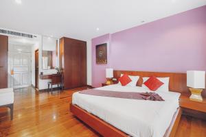 a bedroom with a large bed and a desk at Chateau Dale Boutique Resort Spa Villas in Pattaya South +25 photos