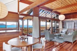 a living room with a table and chairs at Seaside Serenity Getaway in Hawks Nest