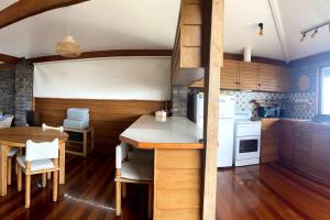 a kitchen with white appliances and a wooden floor at Seaside Serenity Getaway in Hawks Nest