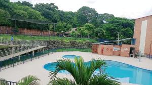 a swimming pool at a park with a playground at Apartamento Amoblado en Ibague in Ibagué