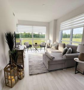 a living room with a couch and a large window at 2 bedroom 2 bath Aquarius, Friday Harbour, Innisfil, Barrie in Innisfil