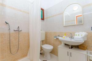 a bathroom with a shower and a toilet and a sink at Apartments Bosiljka - by the sea in Sevid