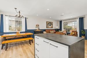a kitchen and living room with a table and chairs at Hot Tub, Games, King Bed, Fire Pit, BBQ Grill, minutes from National Park and Views in Joshua Tree +25 photos