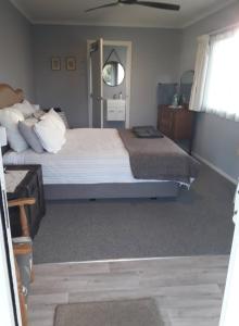 a bedroom with two beds and a window at Country View Sleepout in Hamilton