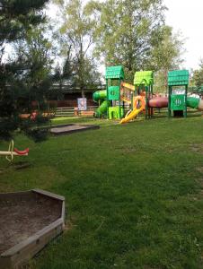 a park with a playground with a slide at Căsuța Bunicilor in Dorna Cîndrenilor
