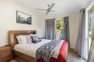 a bedroom with a bed and a ceiling fan at Fiery, cozy starry nights - Farm stay! in Bellthorpe