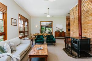 a living room with a couch and a fireplace at Historic Riverfront Residence Farmstay in Cullenbone