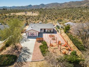 an aerial view of a house with a yard at Hot Tub, Games, King Bed, Fire Pit, BBQ Grill, minutes from National Park and Views in Joshua Tree