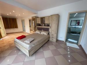 a bedroom with a large bed and a tiled floor at Villa vue sur mer in El Djamila