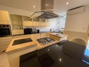 a kitchen with a stove top oven next to a counter at Villa vue sur mer in El Djamila