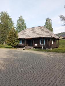 a house with a brick driveway in front of it at Căsuța Bunicilor in Dorna Cîndrenilor