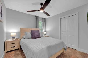 a bedroom with a bed and a ceiling fan at SideB#JaxBeachRetreat w/Gameroom and BackyardOasis in Jacksonville Beach