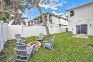 a group of chairs sitting around a fire pit in a yard at SideB#JaxBeachRetreat w/Gameroom and BackyardOasis in Jacksonville Beach