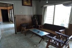 a living room with a couch and chairs and a table at DK Hotel Singaraja in Singaraja