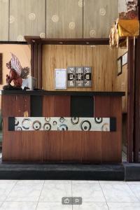 a reception desk in a building with wood paneling at DK Hotel Singaraja in Singaraja