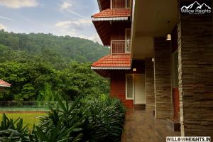 a building with a balcony with a view of a mountain at Willow Heights in Athirappilly