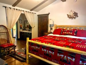 1 dormitorio con 1 cama grande y edredón rojo en Cozy Bird house w Big screen!, en Mount Hood Village