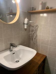 W łazience znajduje się biała umywalka i lustro. w obiekcie Villa Marquise w mieście Canet-en-Roussillon