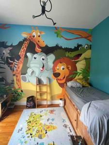 a bedroom with a mural of animals on the wall at Manornella, beaux volumes, grand garage idéal Mas du Clos in Aubusson