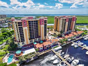 an aerial view of a resort with boats in a harbor at Vista Del Mar at Cape Harbour Marina, 10th Floor Luxury Condo, King Bed, Views! in Cape Coral